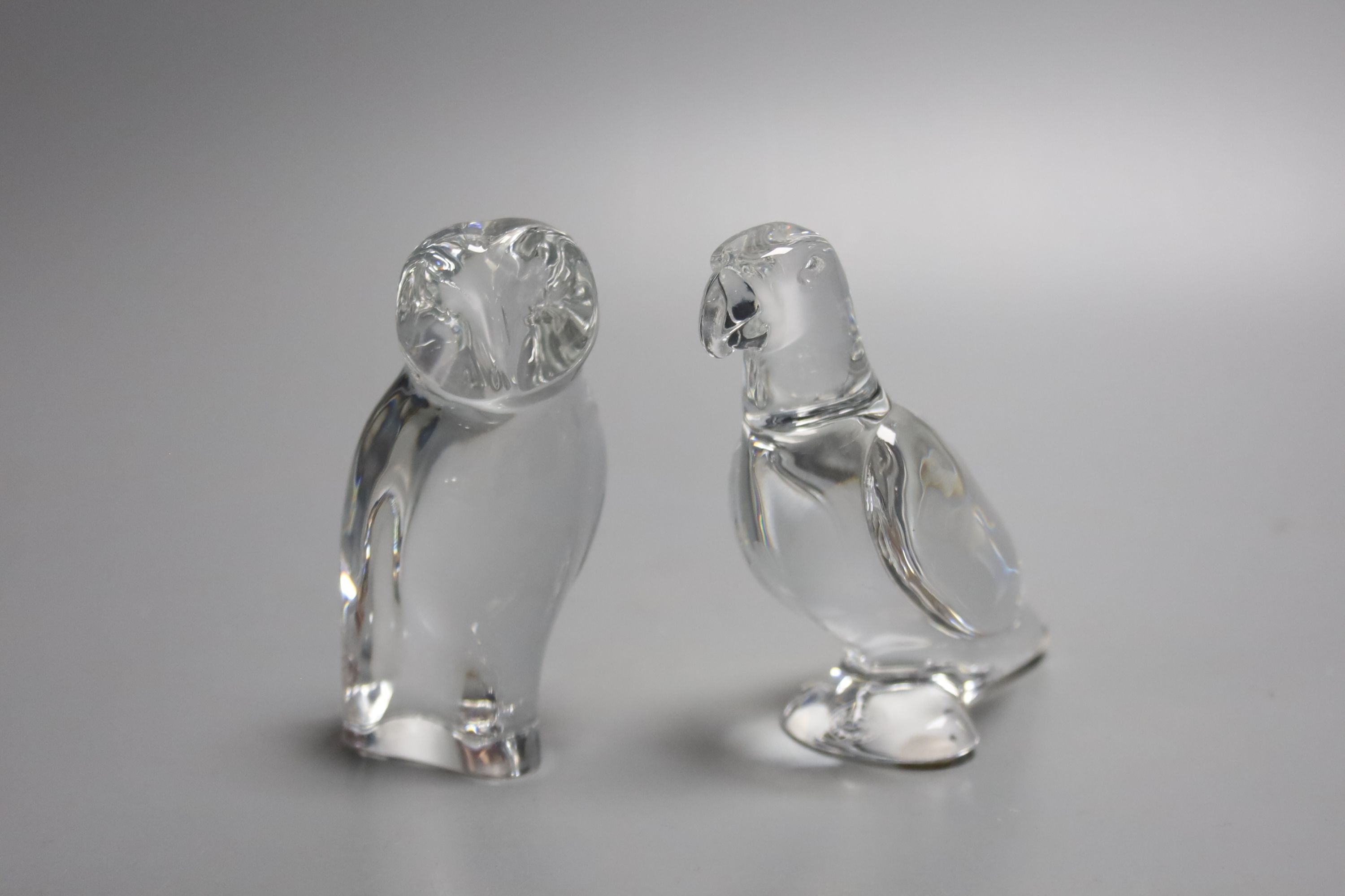 A Baccarat crystal figure of a barn owl, 10cm high, together with a Baccarat crystal figure of a parrot, 10cm high